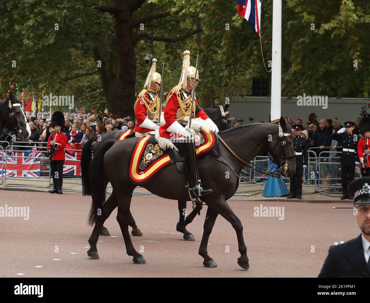 Mounted Horse Guards in their historic colourful uniforms accompany the funeral procession for Queen Elizabeth II on The Mall, London, UK Stock Photo
