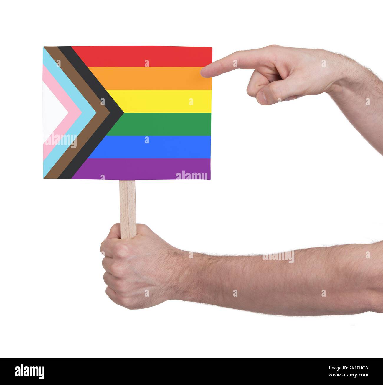 Hand holding banner on wood stick, isolated - Progress LGBTQ Rainbow flag Stock Photo