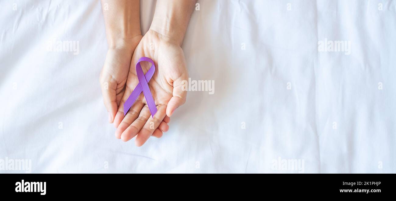 Pancreatic Cancer, testicular, world Alzheimer, epilepsy, lupus and violence day Awareness month, Woman holding purple Ribbon for supporting people li Stock Photo
