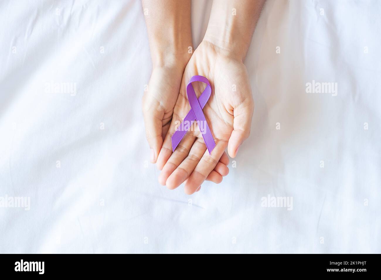 Pancreatic Cancer, testicular, world Alzheimer, epilepsy, lupus and violence day Awareness month, Woman holding purple Ribbon for supporting people li Stock Photo
