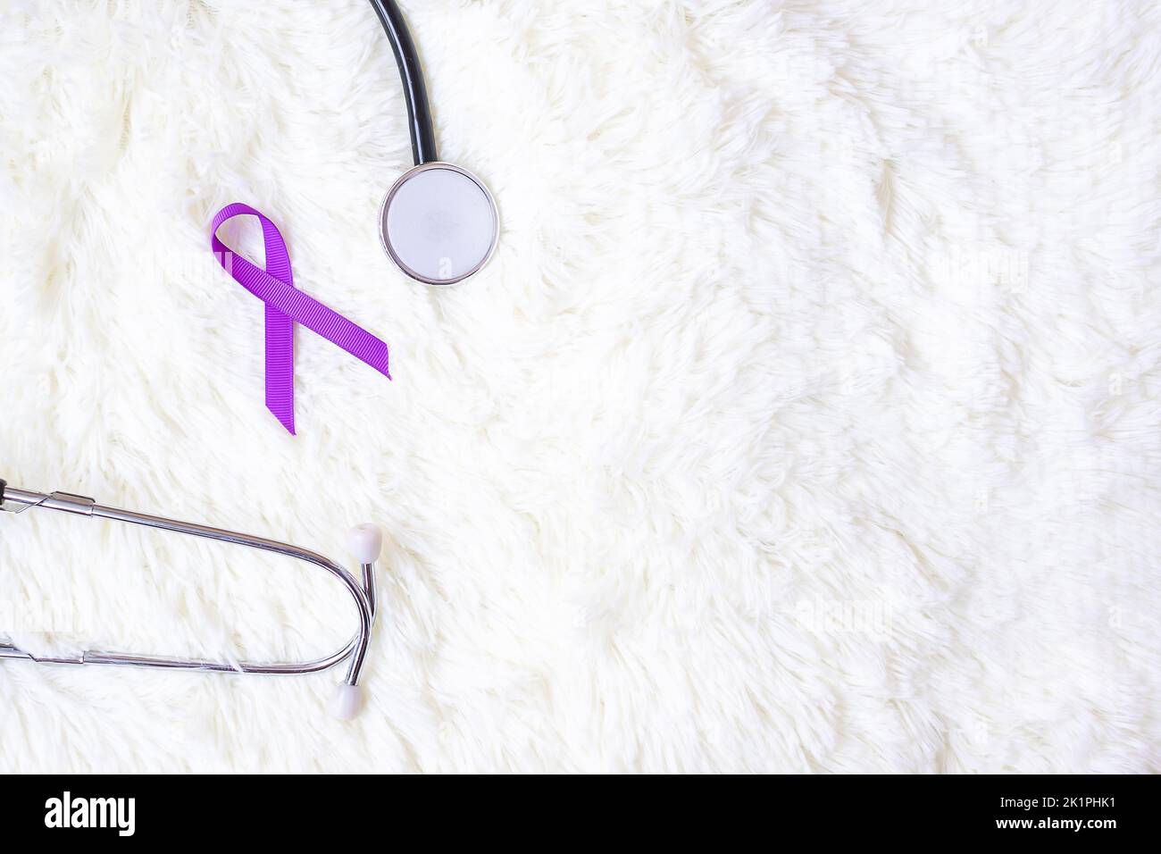 Pancreatic Cancer, world Alzheimer, epilepsy, lupus and domestic violence day Awareness month, Woman holding purple Ribbon with stethoscope. Healthcar Stock Photo