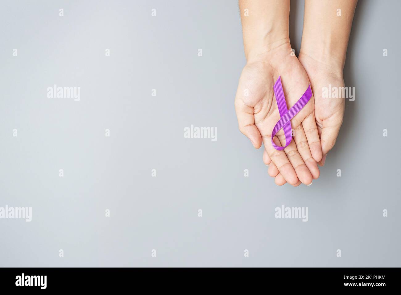 Pancreatic Cancer, world Alzheimer, epilepsy, lupus and domestic violence day Awareness month, Woman holding purple Ribbon for supporting people livin Stock Photo