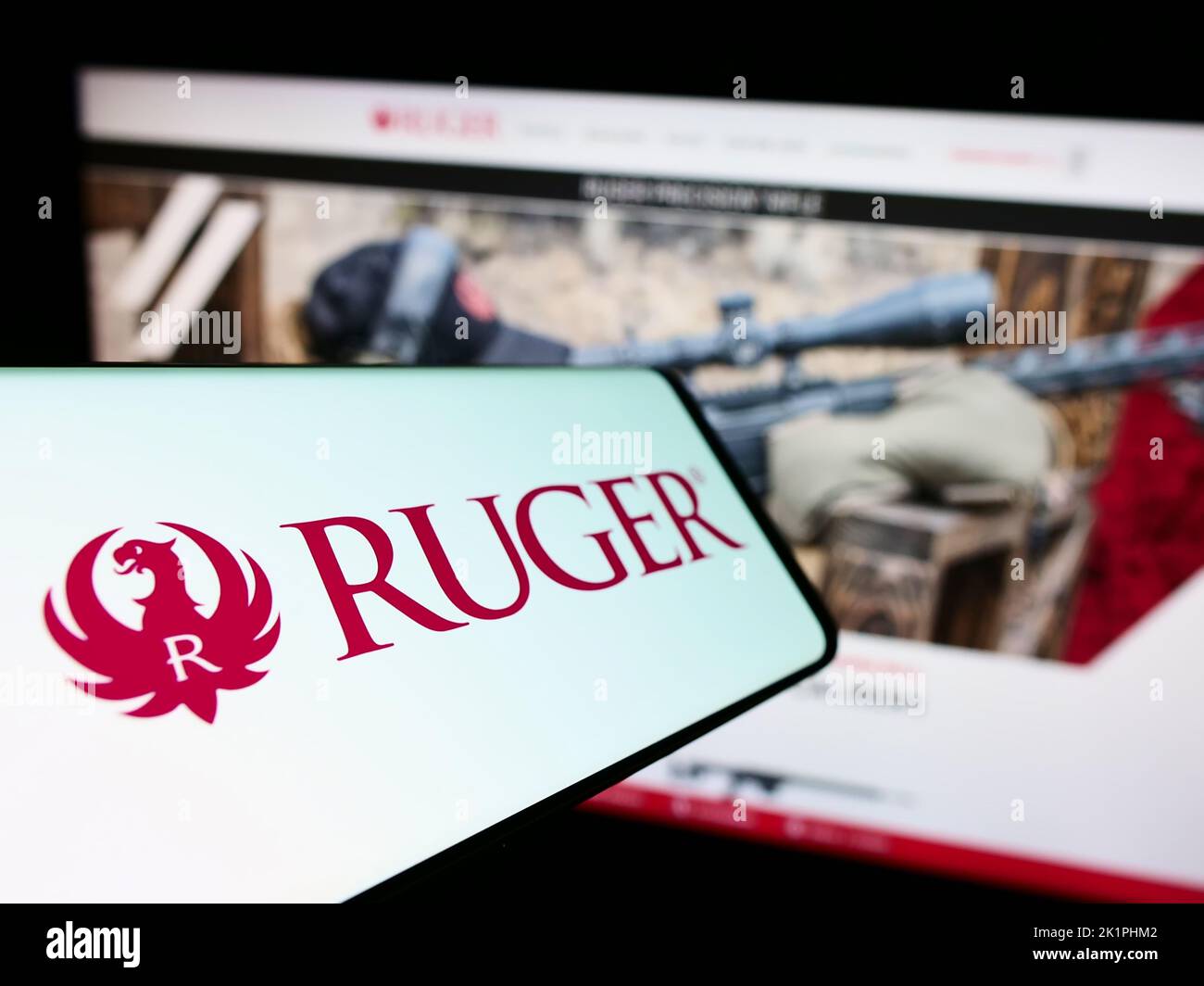 Cellphone with logo of American company Sturm, Ruger and Company Inc. on screen in front of website. Focus on center-left of phone display. Stock Photo