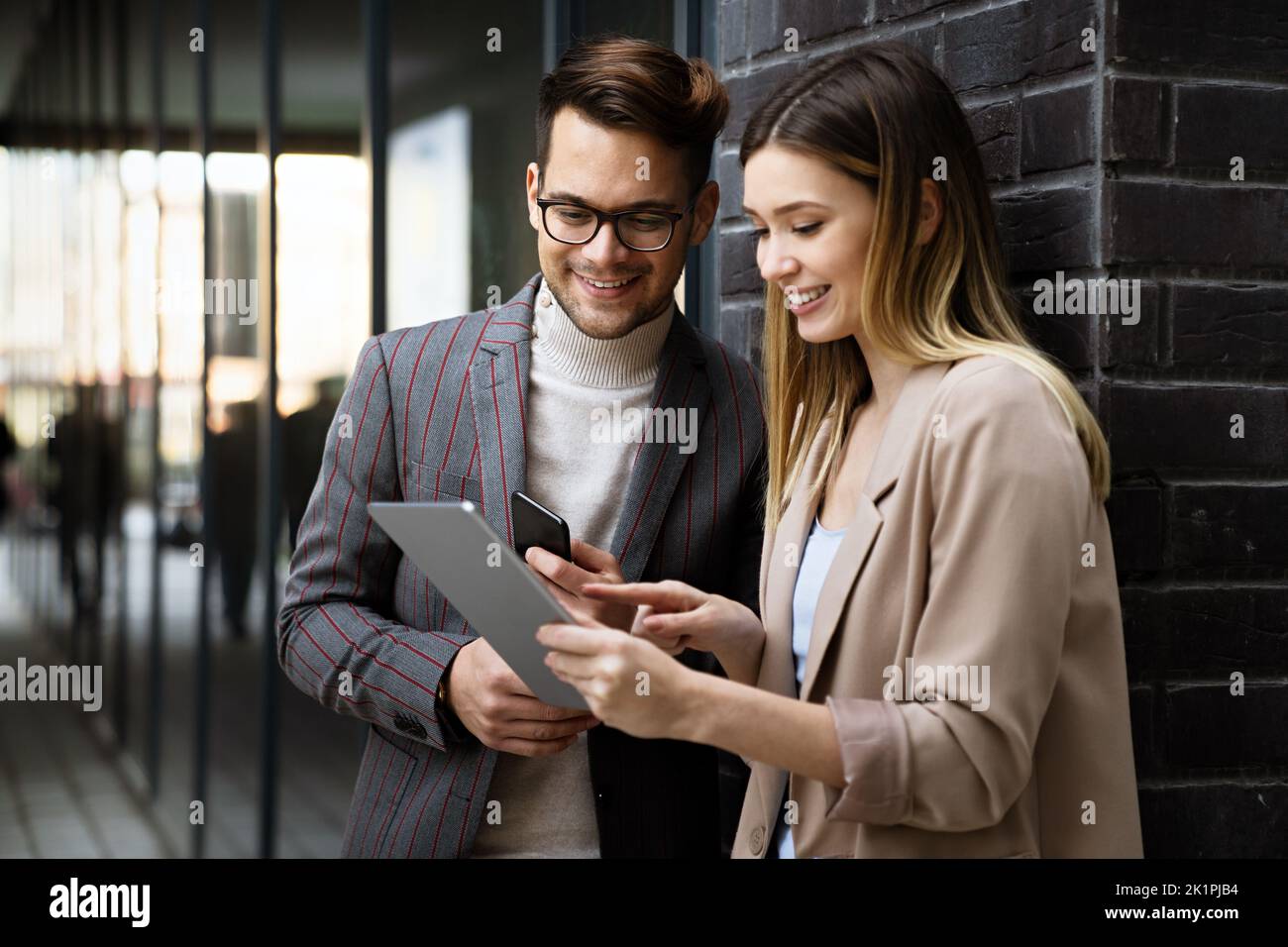 Portrait of successful business people working, talking together in urban background. Stock Photo