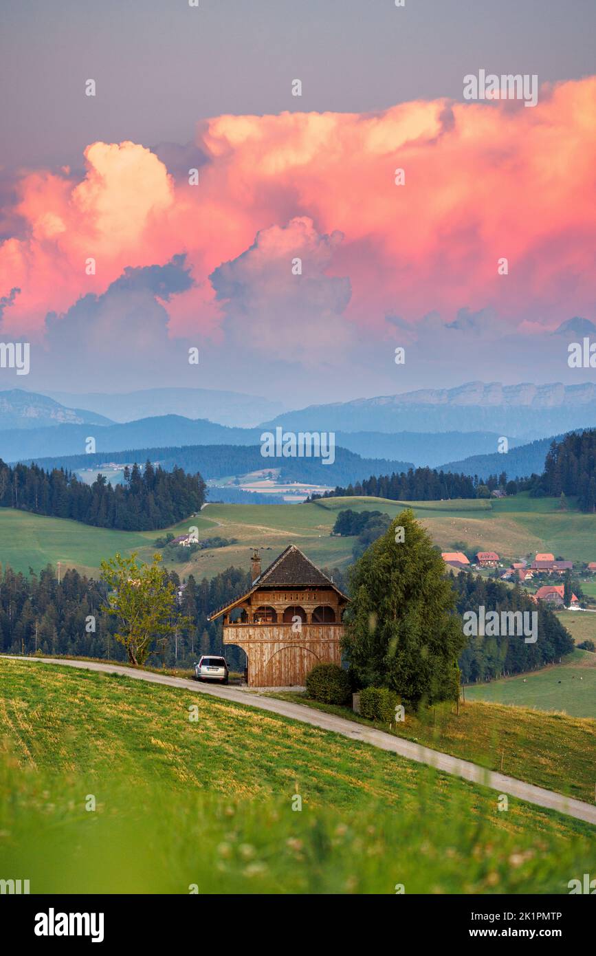 classical Emmental farmhouse at a summer sunset Stock Photo