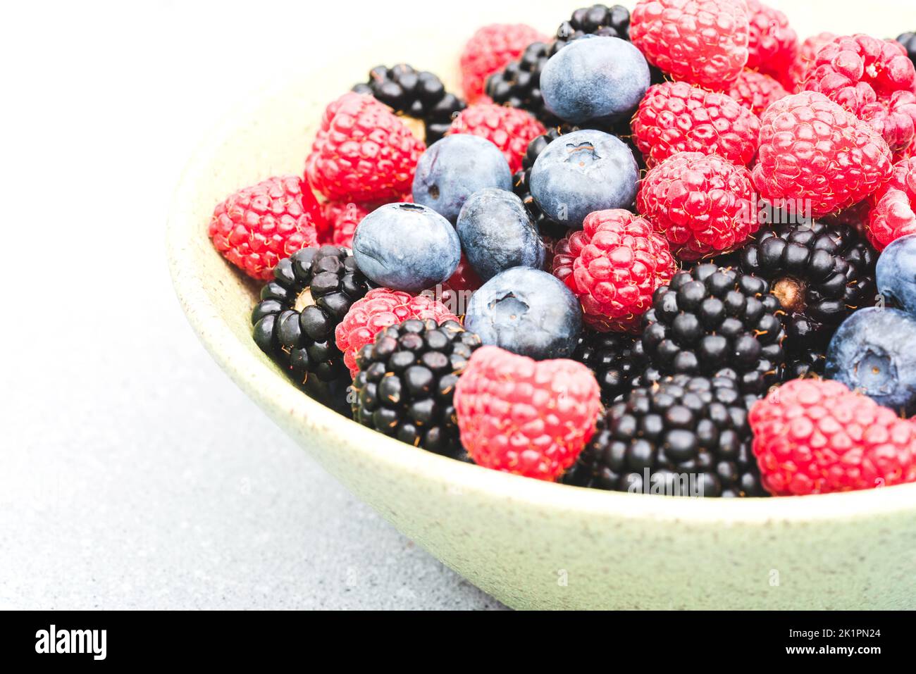 Bowl with freshly picked garden berries - raspberry, blackberry ...