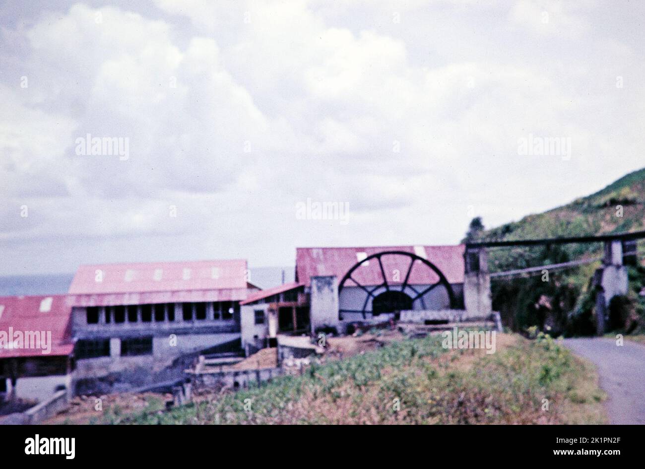 Poor Focus - Waterwheel providing power for arrowroot factory, St Vincent, Windward Islands, West Indies, 1962 Stock Photo