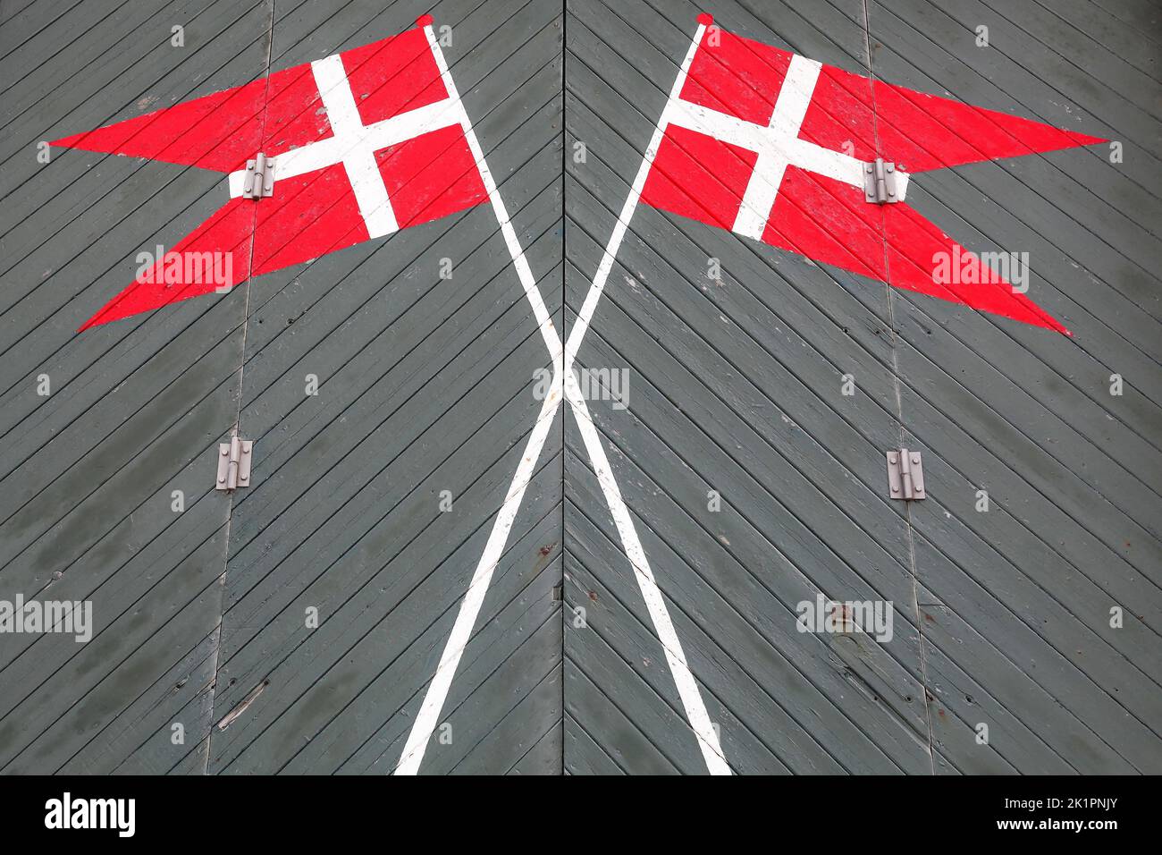 Danish flags on a green door of a rescue station in Blavand, Denmark Stock Photo