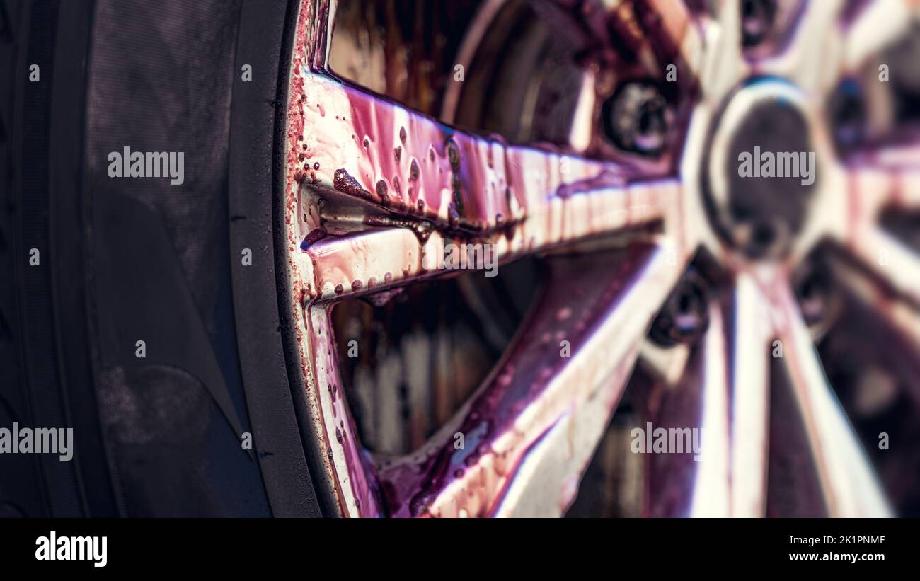Car wash. Auto wheel cleaning process. Rim cleaner with chemical