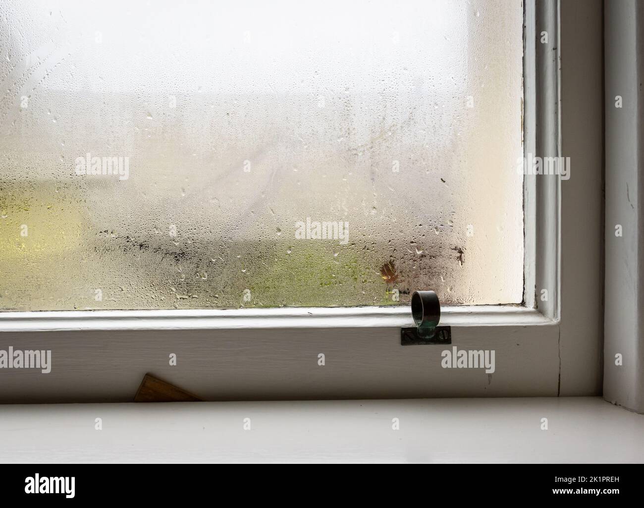 Condensation on an old window in winter time Stock Photo