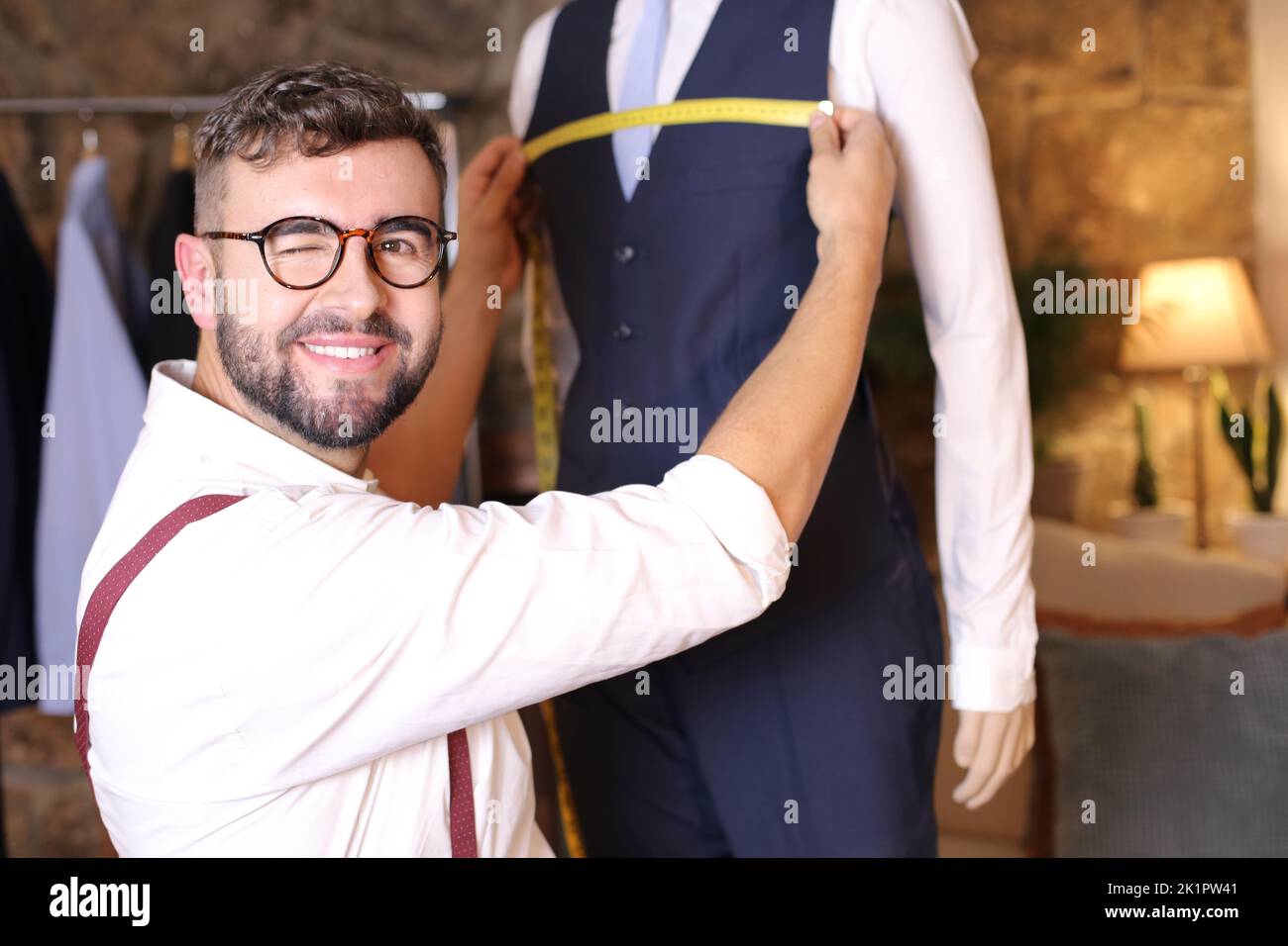 Male fashion designer taking some measurements Stock Photo Alamy