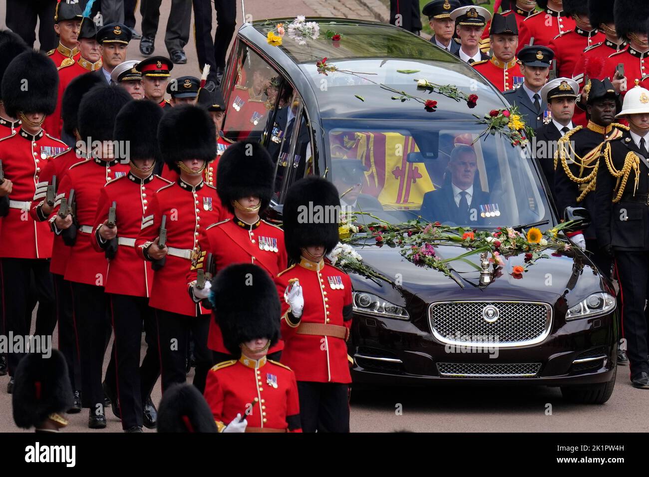 Grenadier Guards escort the State Hearse carrying the coffin of Queen Elizabeth II, draped in the Royal Standard with the Imperial State Crown and the Sovereign's Orb and Sceptre, during the Ceremonial Procession through Windsor Castle to a Committal Service at St George's Chapel. Picture date: Monday September 19, 2022. Stock Photo