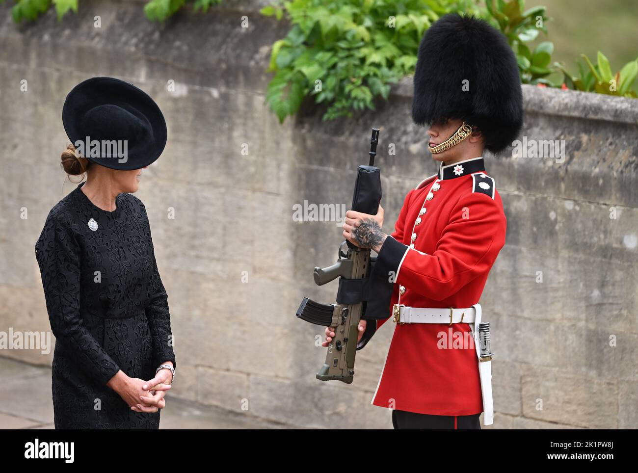 A guest glances at a member of the Coldstream Guards as they arrive for