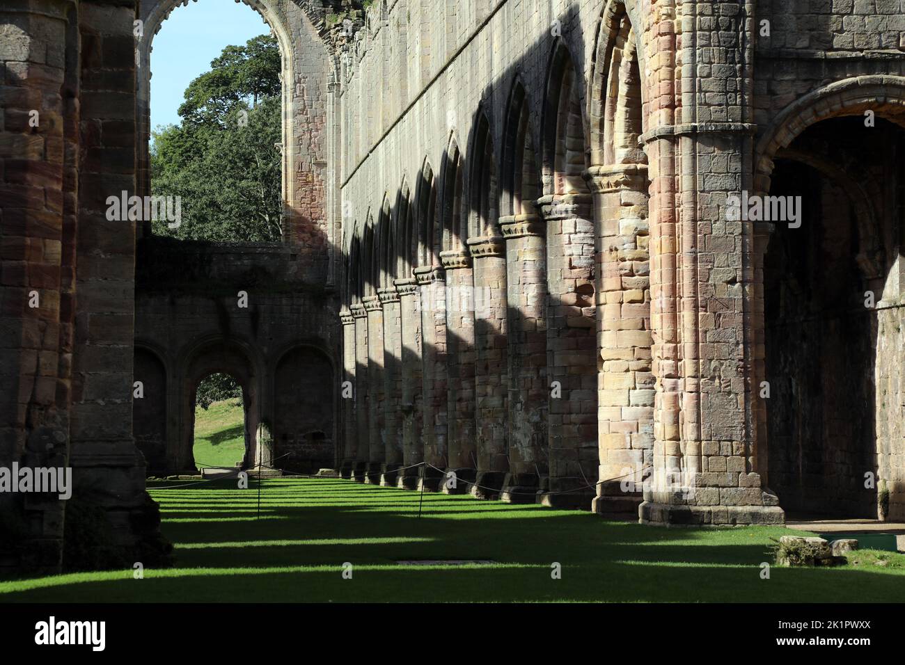 Interior of the ruined Fountains Abbey church looking down the nave, in North Yorkshire, England, UK. Stock Photo