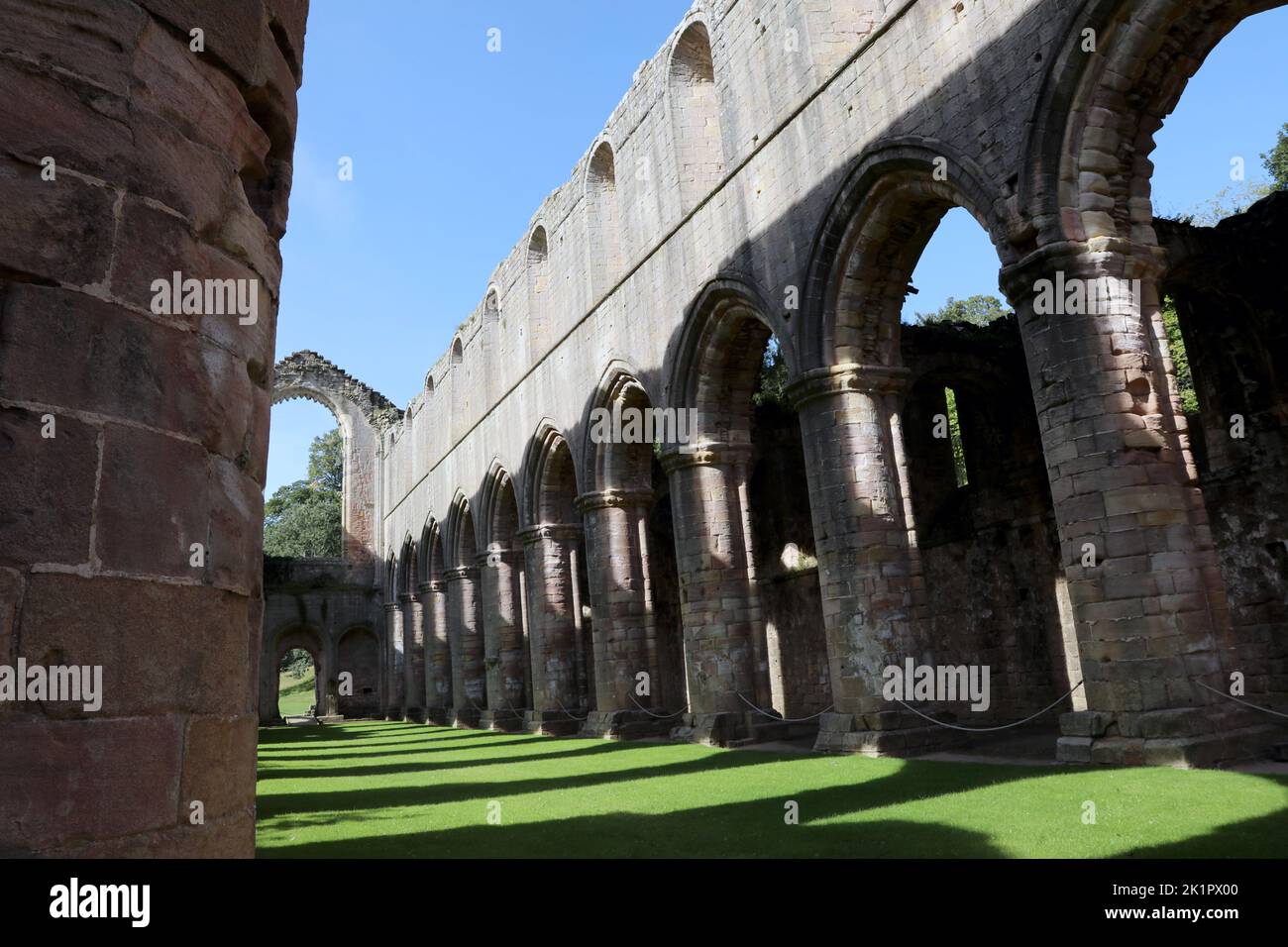 Interior of the ruined Fountains Abbey church looking down the nave, in North Yorkshire, England, UK. Stock Photo