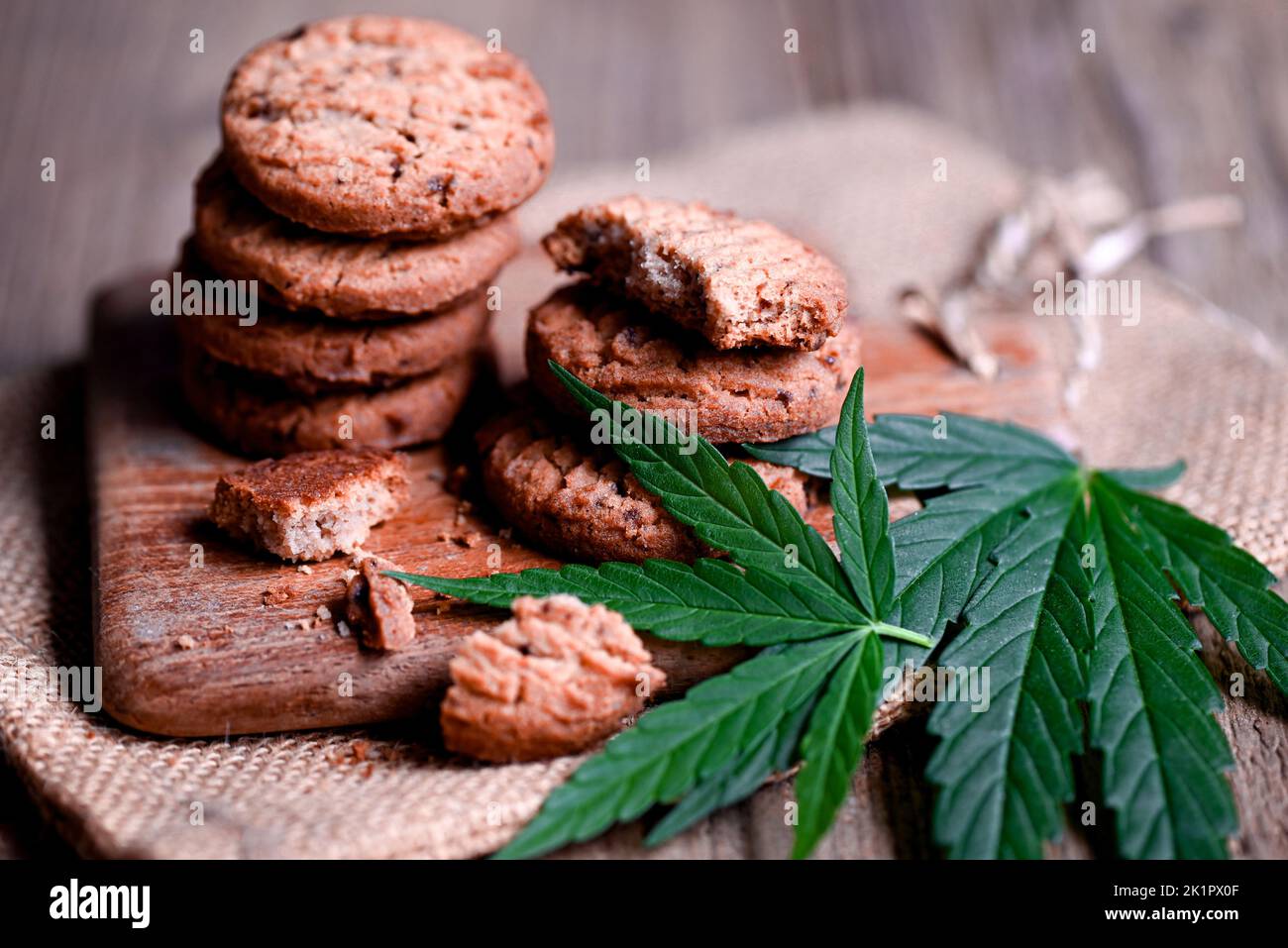 delicious sweet dessert cookie with hemp leaf plant THC CBD herbs food snack and medical, Cannabis food cookies with cake chocolate cannabis leaf mari Stock Photo