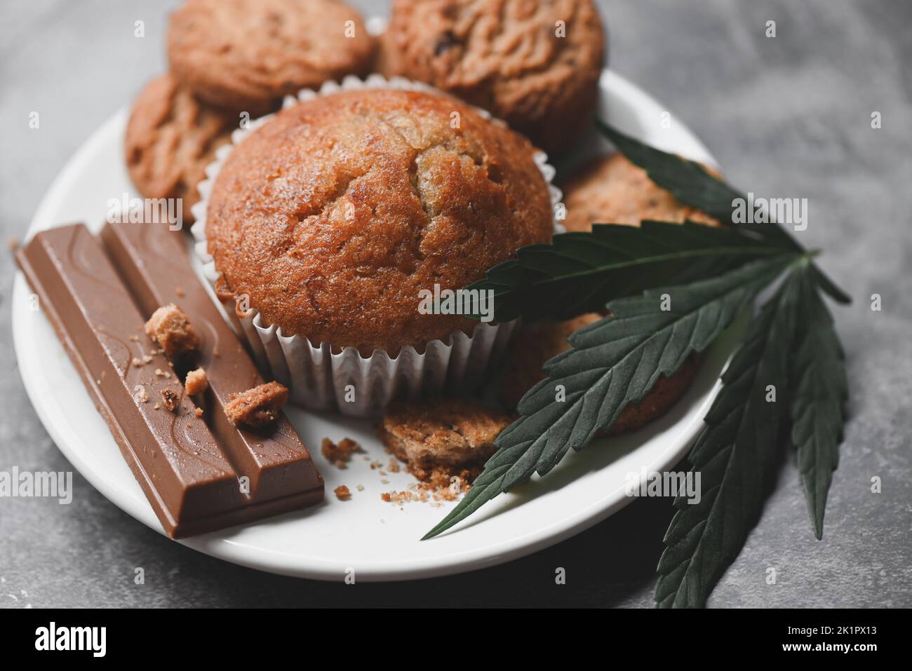 Cannabis food cookies with cake chocolate cannabis leaf marijuana herb on wooden and dark background, delicious sweet dessert cookie with hemp leaf pl Stock Photo