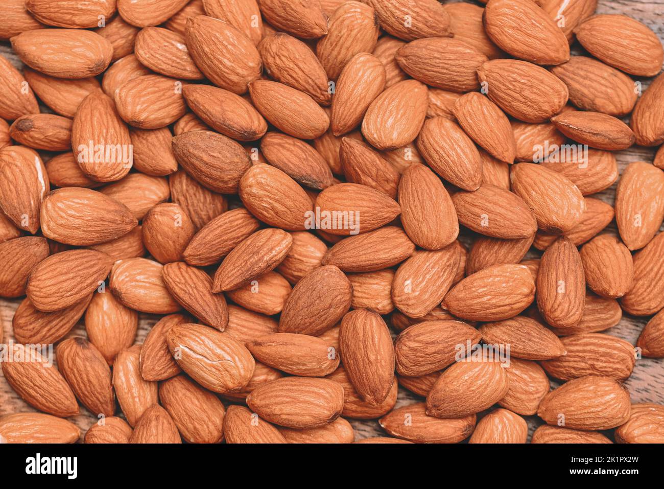 Almonds nuts on background, Close up delicious sweet almonds, roasted almond nut for healthy food and snack - Top view Stock Photo