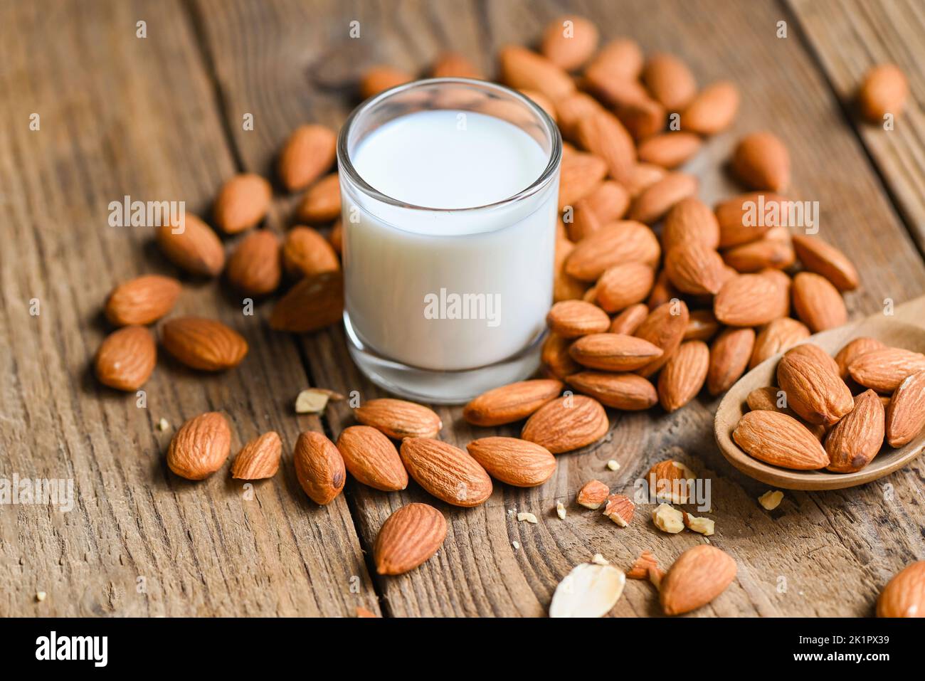 Almond milk and Almonds nuts wooden background, Delicious sweet almonds on table, roasted almond nut for healthy food and snack Stock Photo