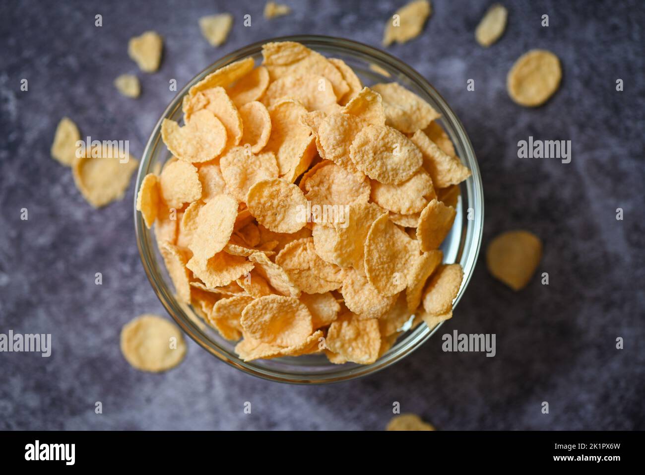 cornflakes bowl breakfast food and snack for healthy food concept, morning breakfast fresh whole grain cereal, cornflakes on dark background - top vie Stock Photo