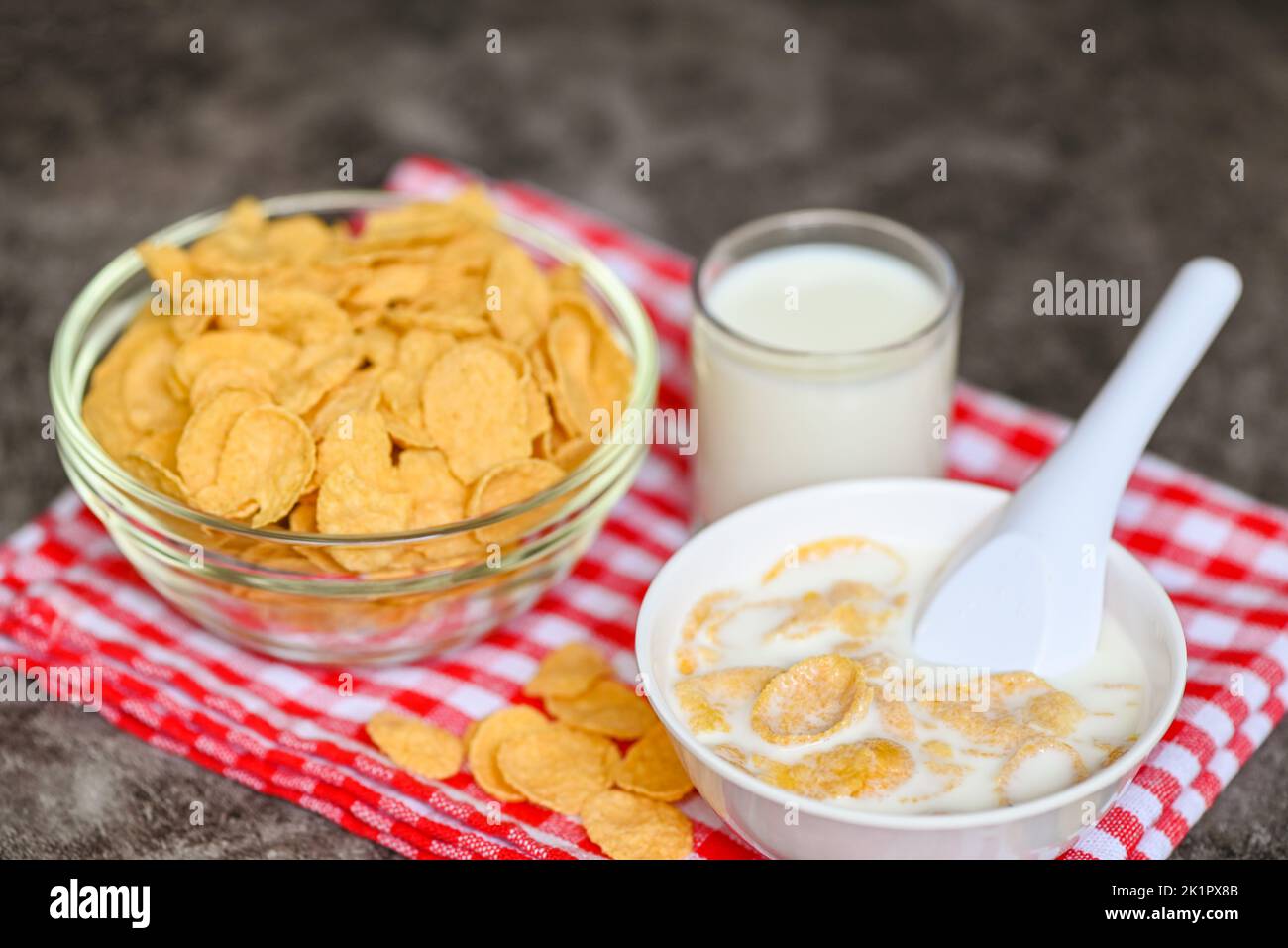 cornflakes bowl breakfast food and snack for healthy food concept, morning breakfast fresh whole grain cereal, cornflakes with milk on dark background Stock Photo