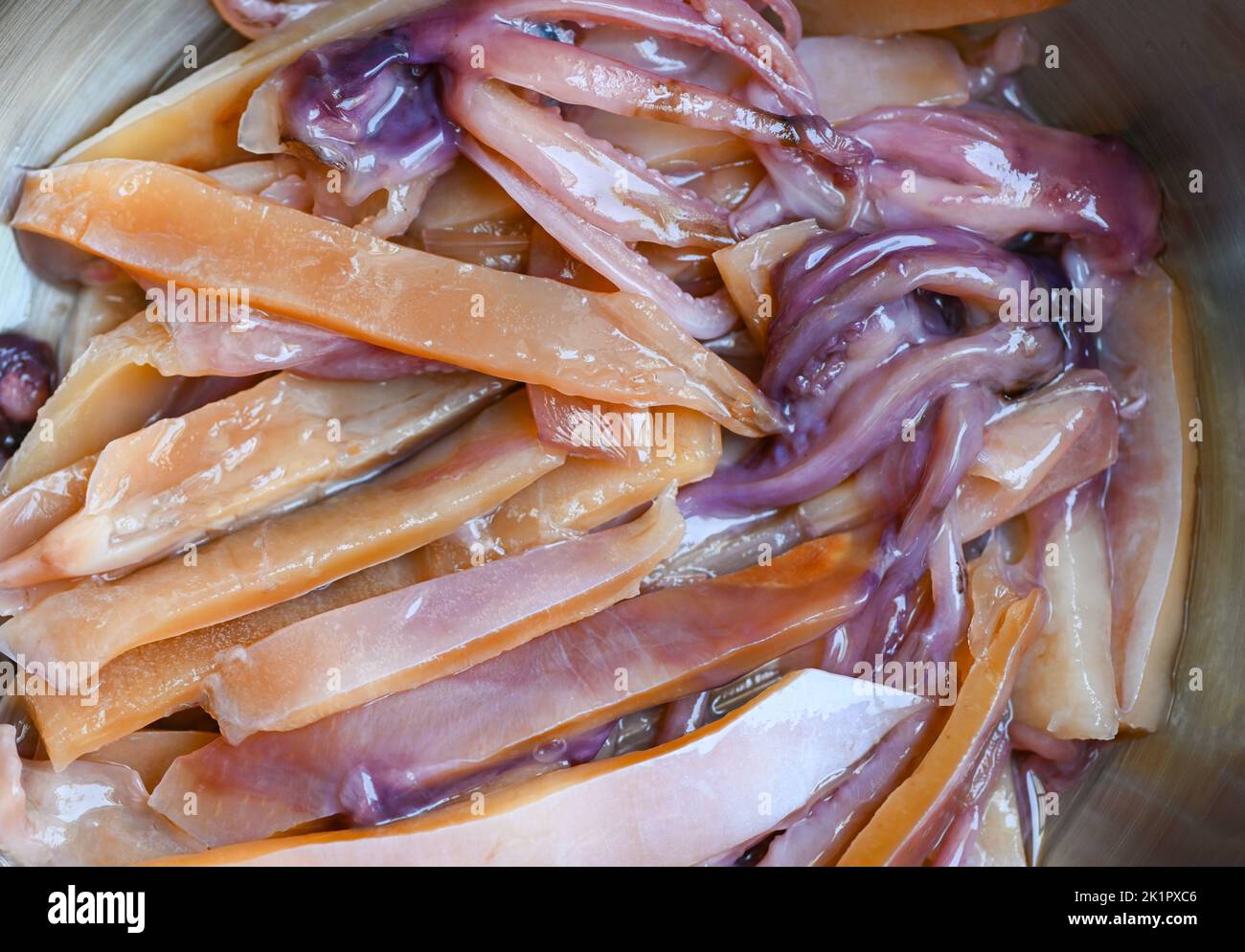 raw squid for cooking food on wooden table, preserving food seafood, pickled squid on bowl Stock Photo