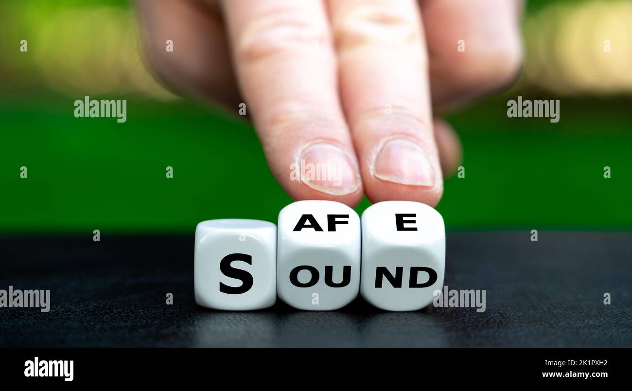Dice form the words safe and sound. Stock Photo
