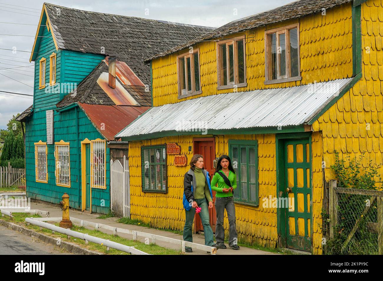 Chile, Quinchao a small island a short ferry trip from Chiloe island -street in Achao with tradinal built wooden houses. Stock Photo