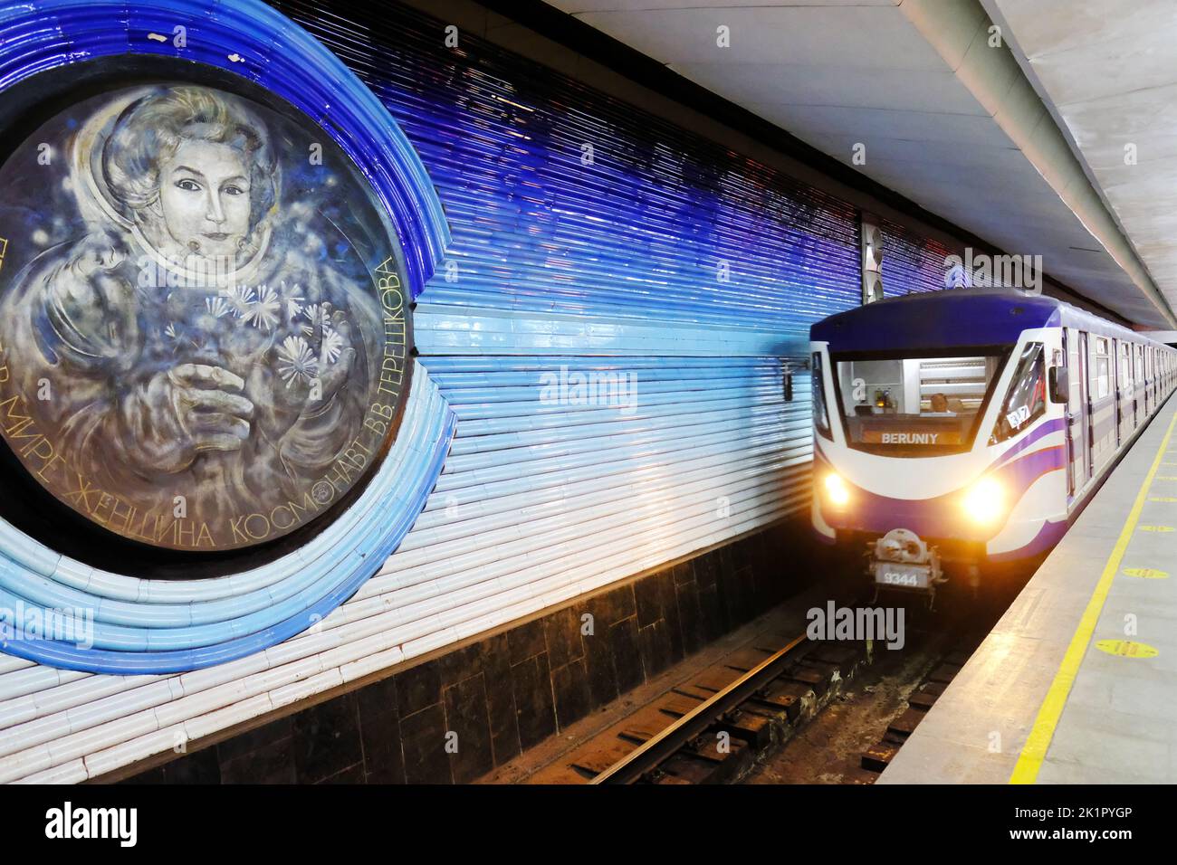Tashkent Uzbekistan metro underground train arriving at Kosmonavtlar station with mural of Russian female cosmonaut Valentina Tereshkova in 2022 Stock Photo