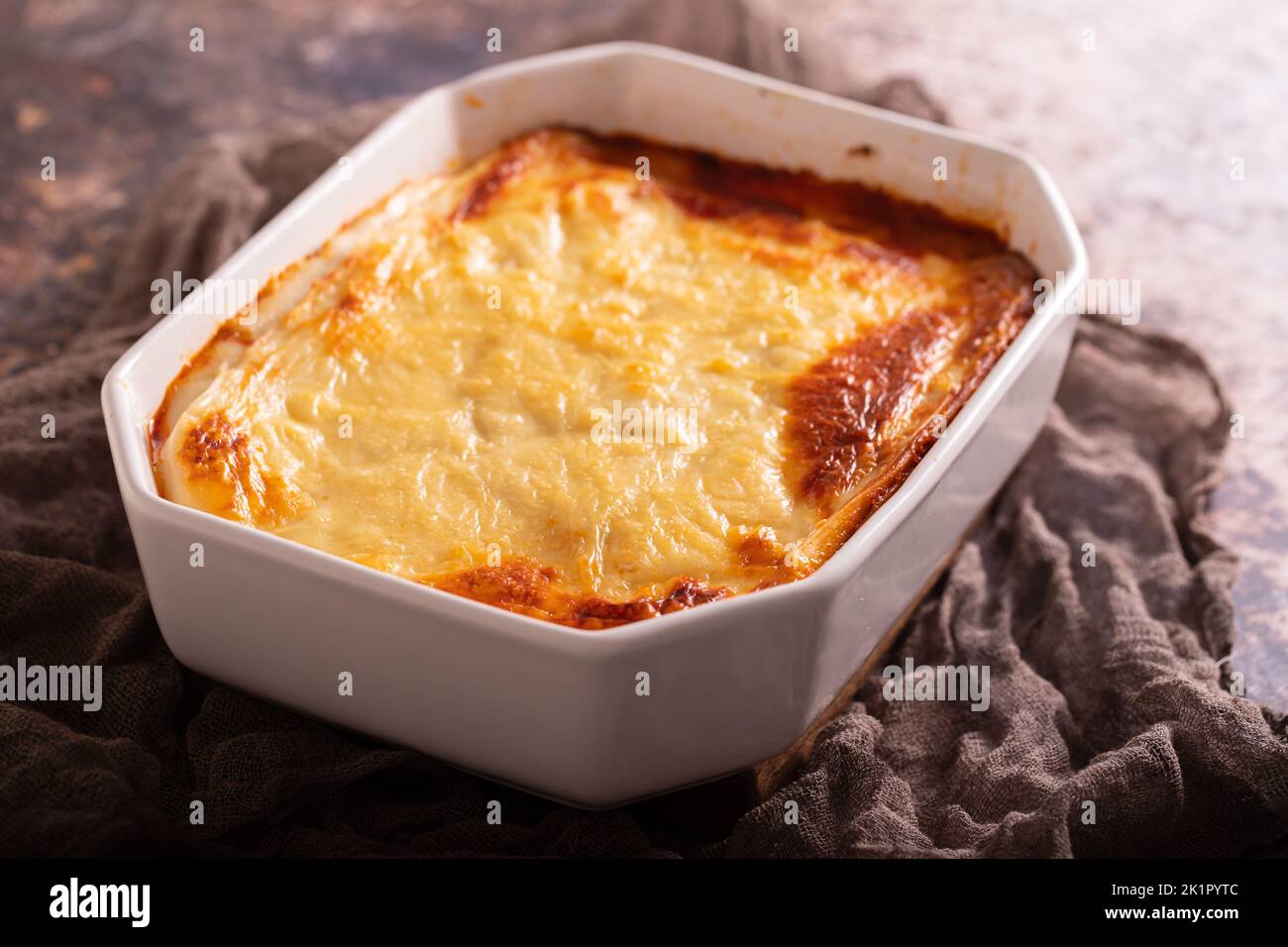 Fresh lasagna with meat and tomato sauce baked in the oven in a ceramic