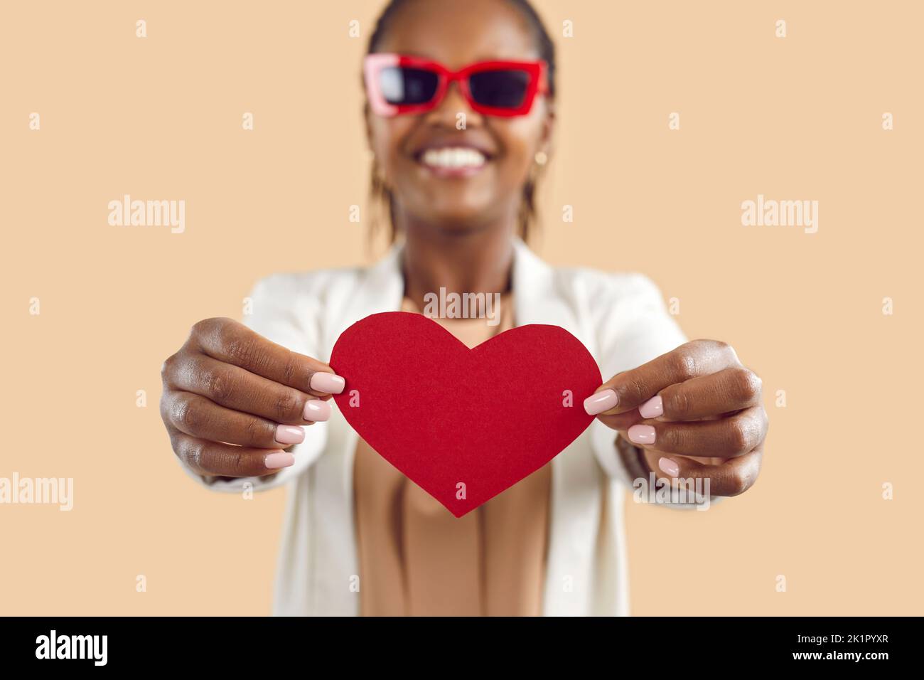 Happy black woman show red paper heart Stock Photo