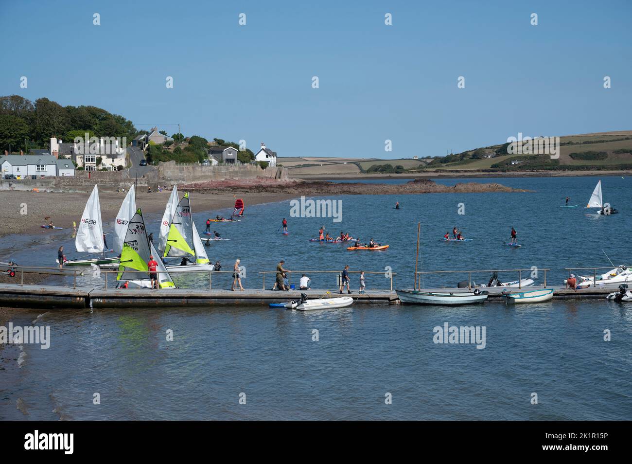 Wales, Pembrokeshire. Dale village. Watersports. Dinghies prepare to set sail. Stock Photo