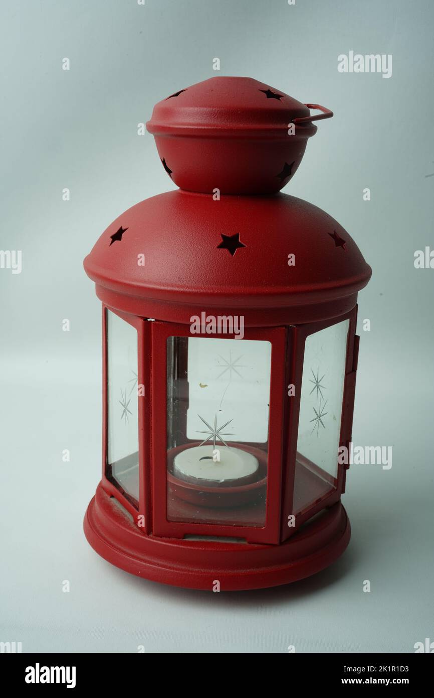 Ornamental Arabic lantern with burning candle glowing in hand. Stock Photo