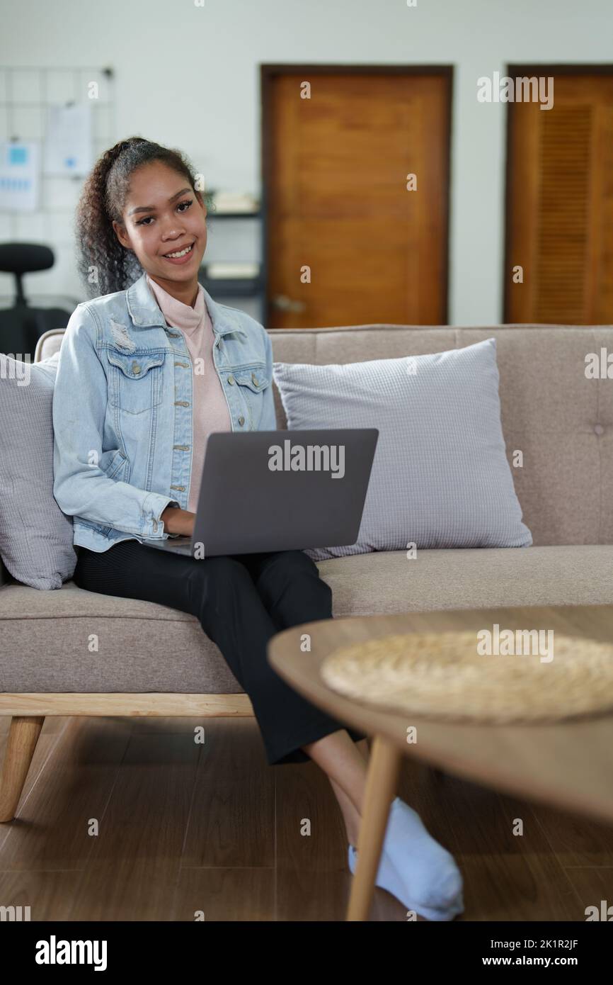 Portrait of a black person using a computer at home Stock Photo