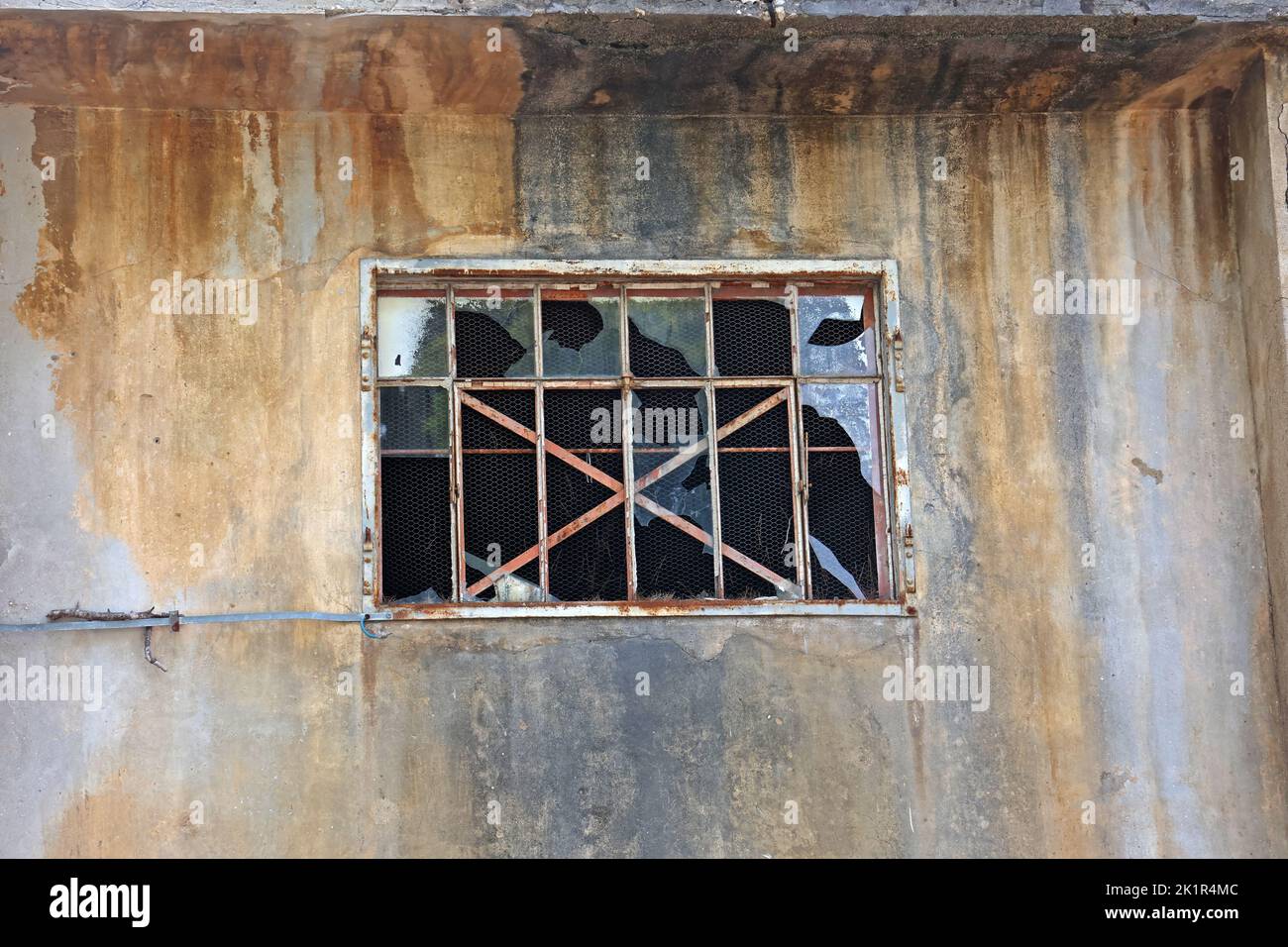 Window with broken windows in an abandoned house. Stock Photo