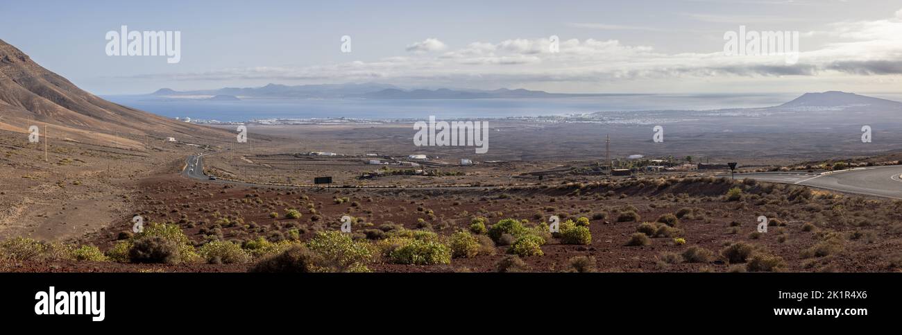 Landscape in the western part of Lanzarote island looking to the city of Playa Blanca and the island of Fuerteventura in the background Stock Photo