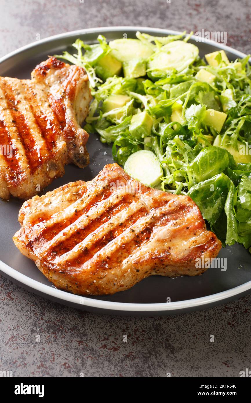 grilled-pork-steak-and-green-vegetable-salad-closeup-in-the-plate-on