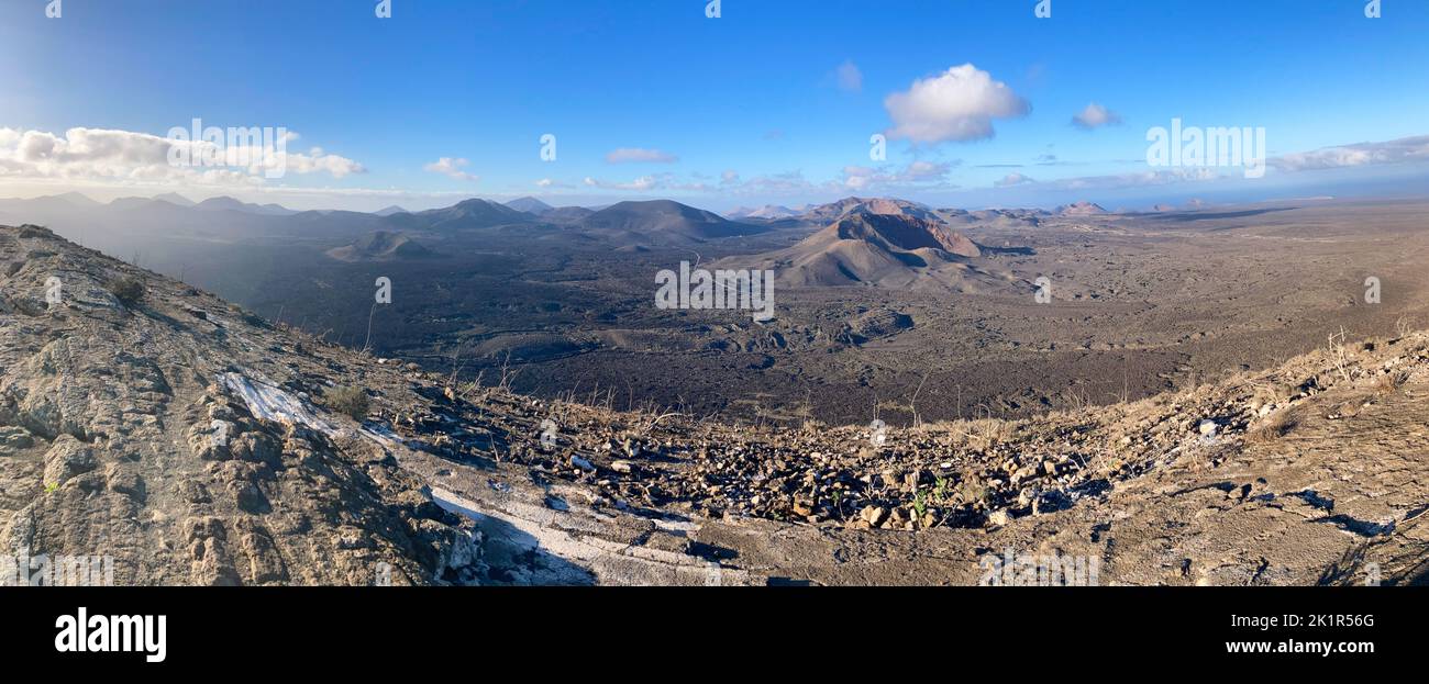 Panoramic image of the Timanfaya National Park shot from the highest point of crater Caldera Blanca on early morning. Lanzarote island, Spain. Stock Photo