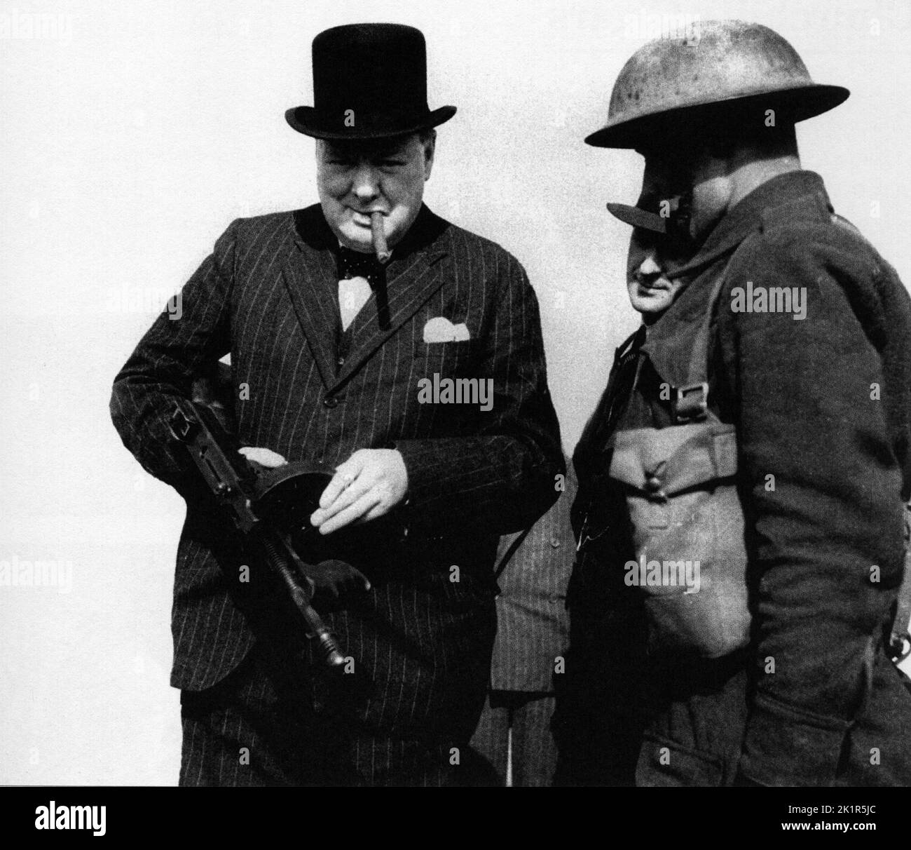 Winston Churchill examines a Thompson sub-machinegun.1940 Stock Photo