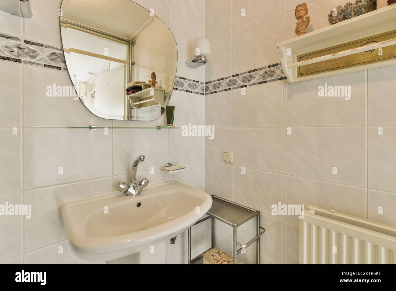 Glass partition between shower tap and wall hung toilet in modern