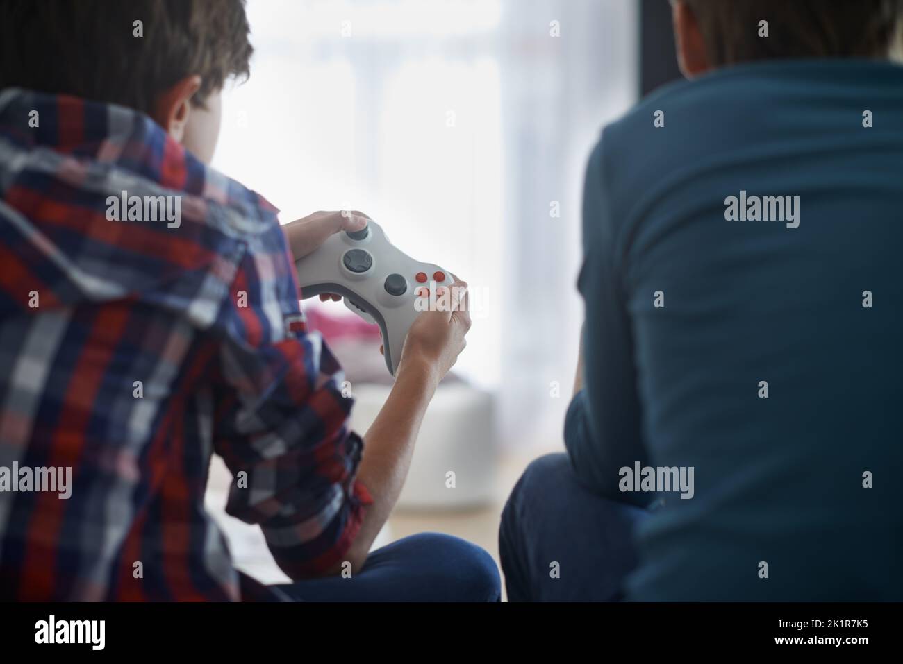 Ive got this in the bag.Rear view of two boys playing video games. Stock Photo