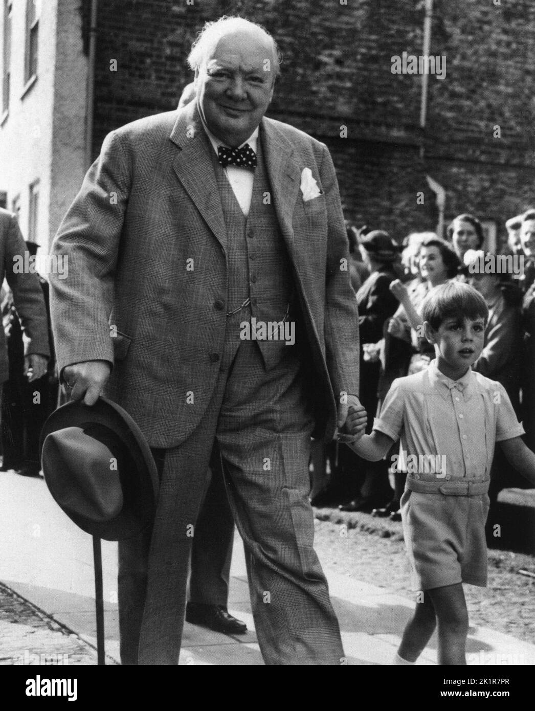 Winston Churchill with his grandson, Nicholas Soames attending a family christening at the church of St Mary the Virgin, Westerham. 1952 Stock Photo