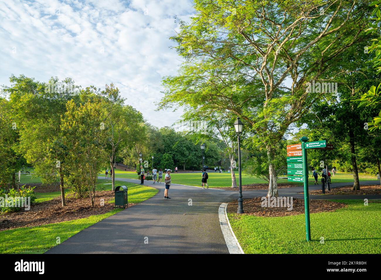 Visitors relaxing in Singapore Botanic Gardens established in 1859 and covering 82 hectares. Stock Photo