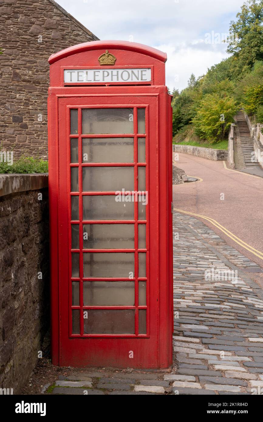 An old red public telephone box on a village street in New Lanark, Lanarkshire, Scotland, UK Stock Photo