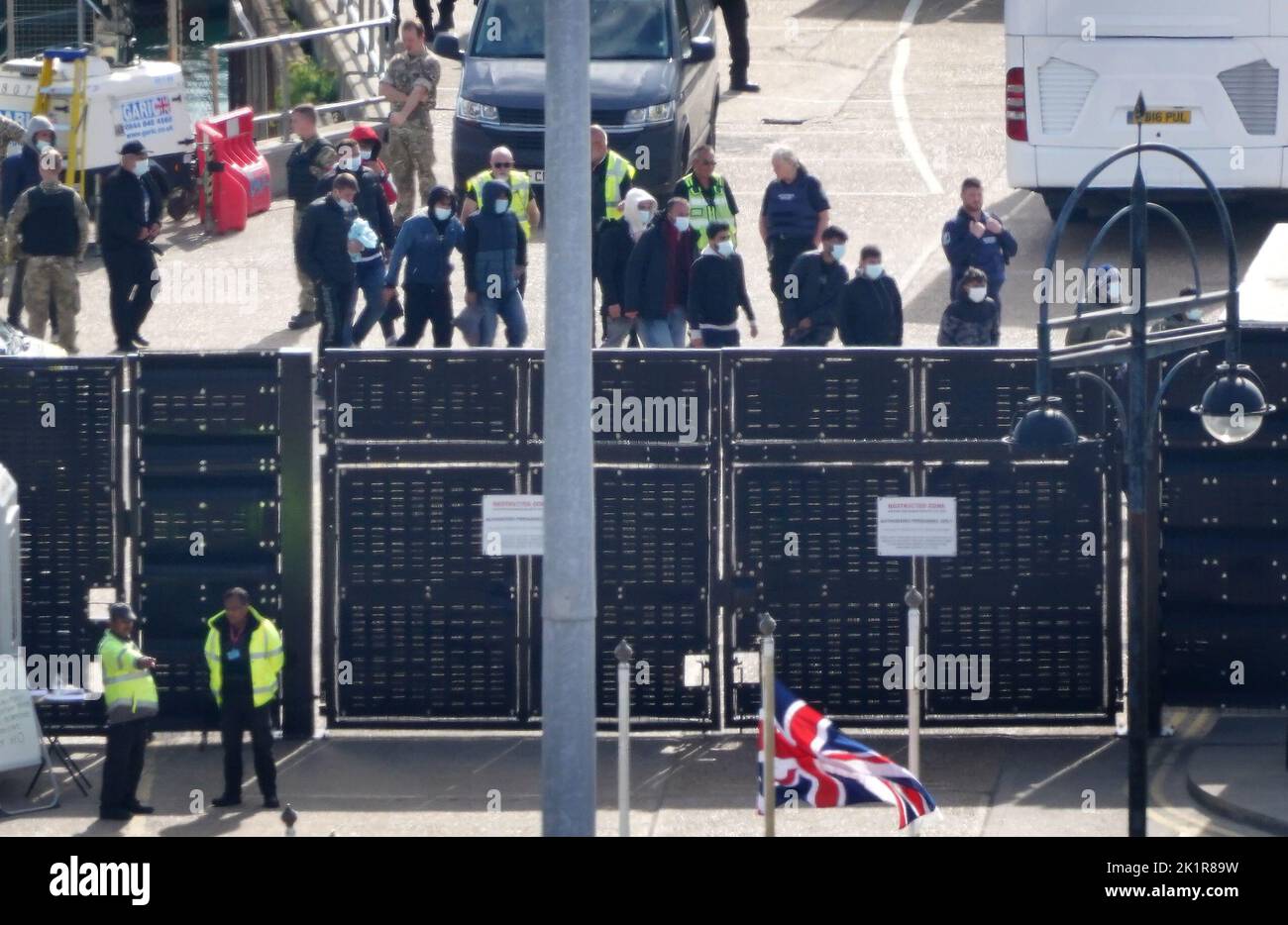 A group of people thought to be migrants walk through the Border Force compound in Dover, Kent, after being brought from a Border Force vessel following a small boat incident in the Channel. Picture date: Tuesday September 20, 2022. Stock Photo