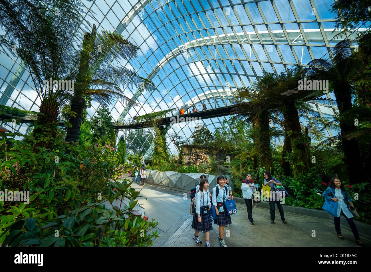 Visitors walking beneath the glass dome of the Cloud Forest, in the Gardens by the Bay, Marina Bay Singapore Stock Photo