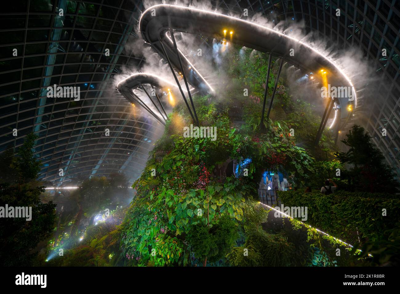 Night view of the 42-metre Cloud Mountain in the Cloud Forest, one of the two vast conservatories in the Gardens by the Bay, Marina Bay Singapore Stock Photo