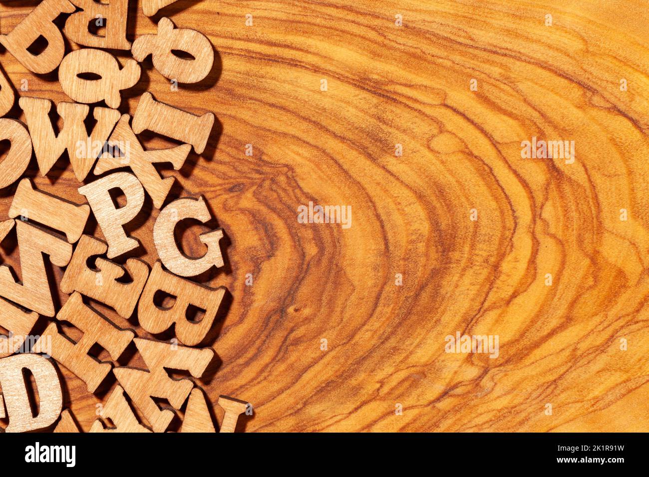 Wooden latin letters with space for text, may be used as backfround Stock Photo