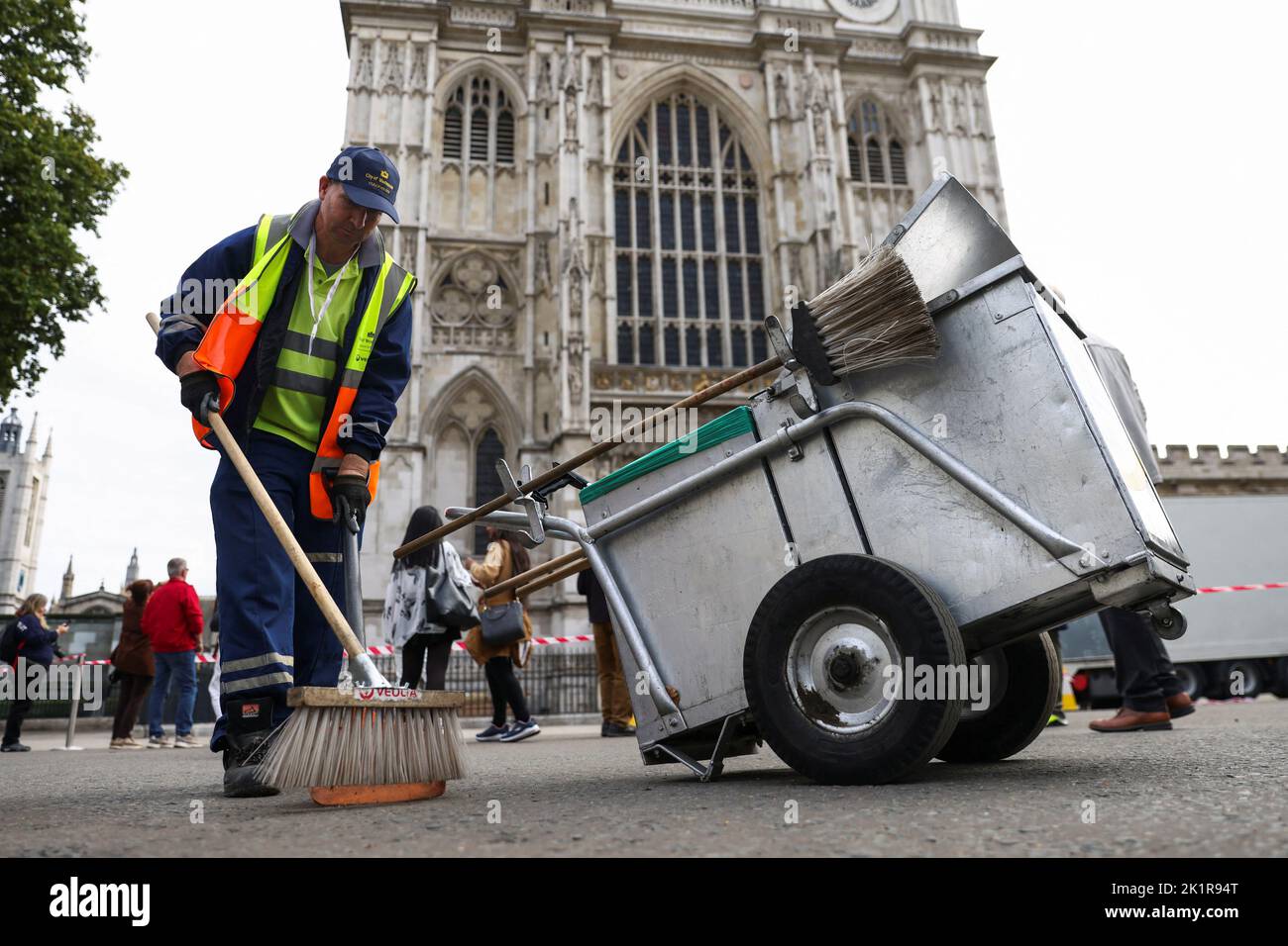 A cleaner sweeps a street outside Westminster Abbey, following the funeral of Britain's Queen Elizabeth, in London, Britain September 20, 2022. REUTERS/Tom Nicholson Stock Photo