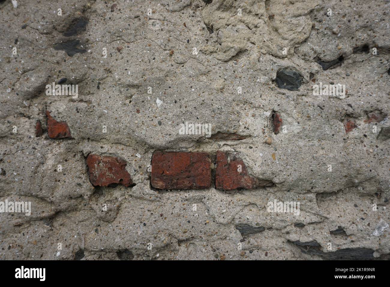 plastered old wall detail, red brick in between Stock Photo